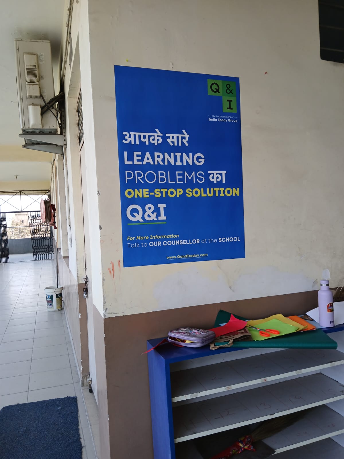 India Today Q&I educational branding poster installed inside a school hall during campaign activity